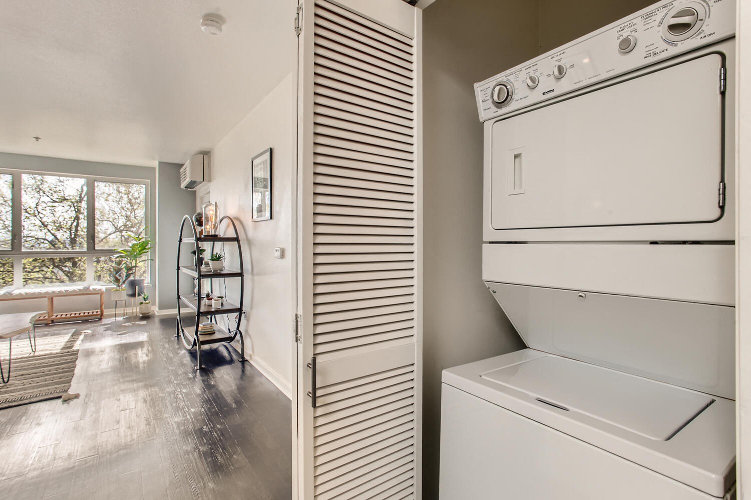 Downtown Portland OR Apartments for Rent - Linc 245 - Living Room Area and In-Unit Laundry Closet with Stacked Machines